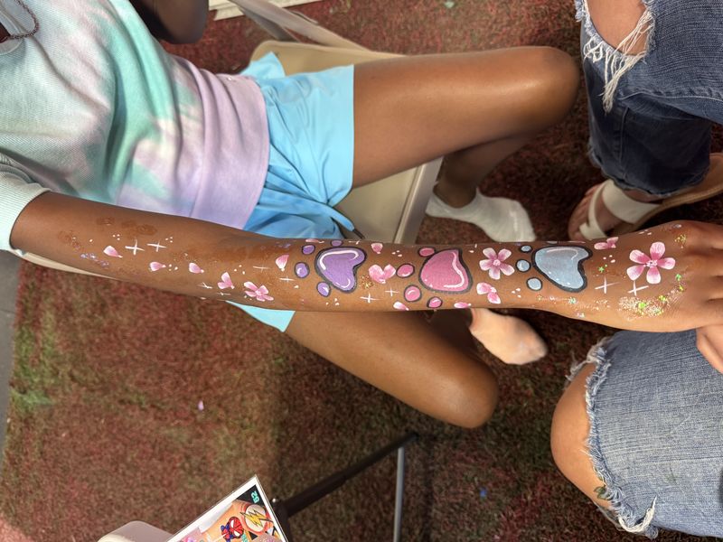 Paw print and flower arm painting at a Texas party