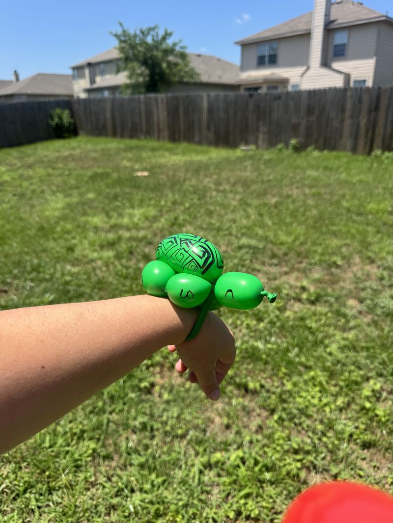 Balloon turtle wrist bracelet at a Texas kids event