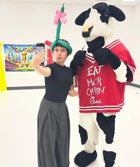 Balloon twisting artist with the Chick-fil-A cow at a Texas corporate event