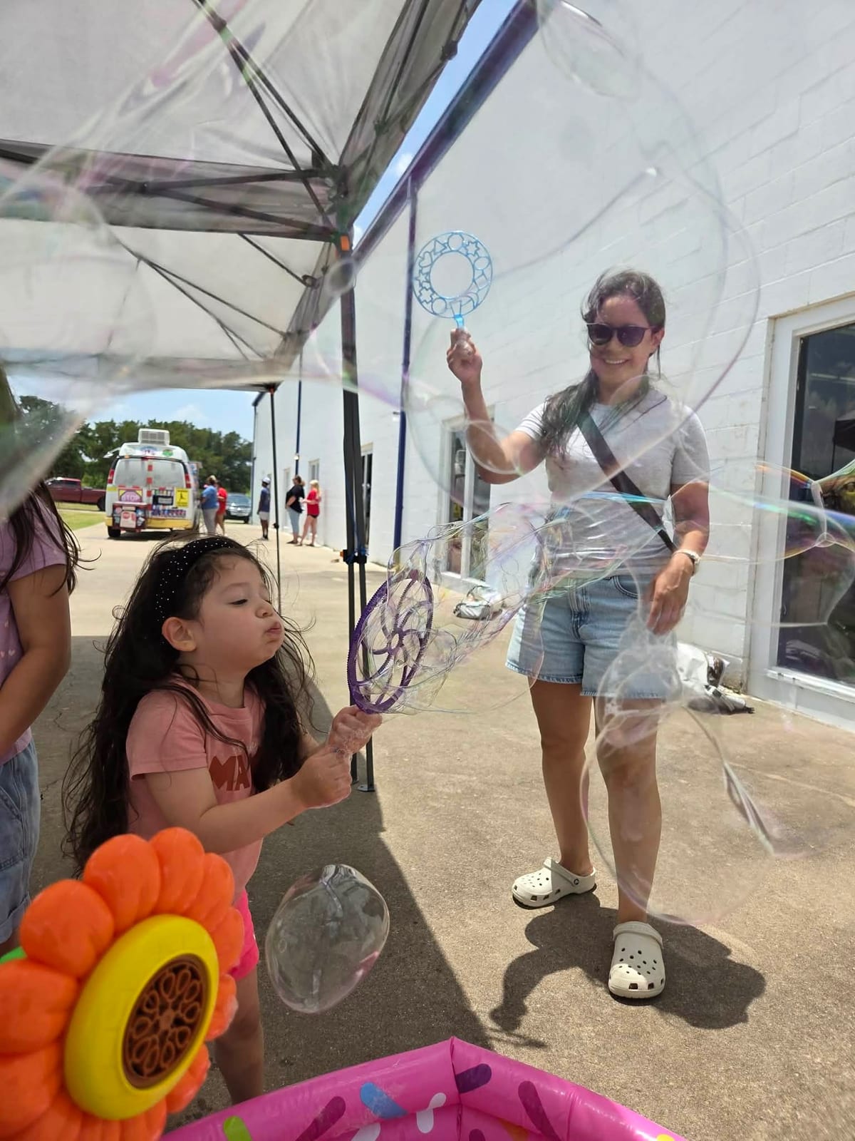 Kids playing with bubbles at a Texas event