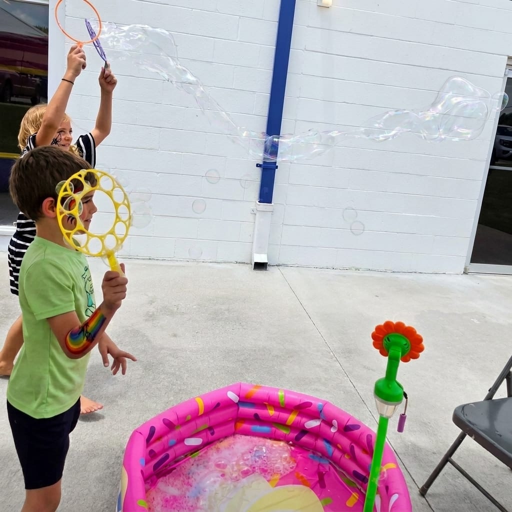 Kids making giant bubbles at a Texas outdoor event
