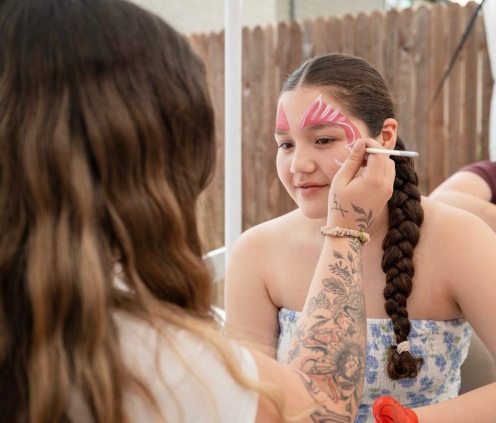 Butterfly face painting on a child at a Texas party