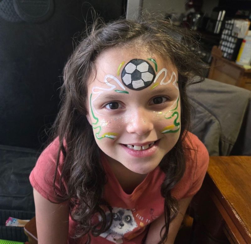 Soccer ball face painting at a kids birthday party in Texas
