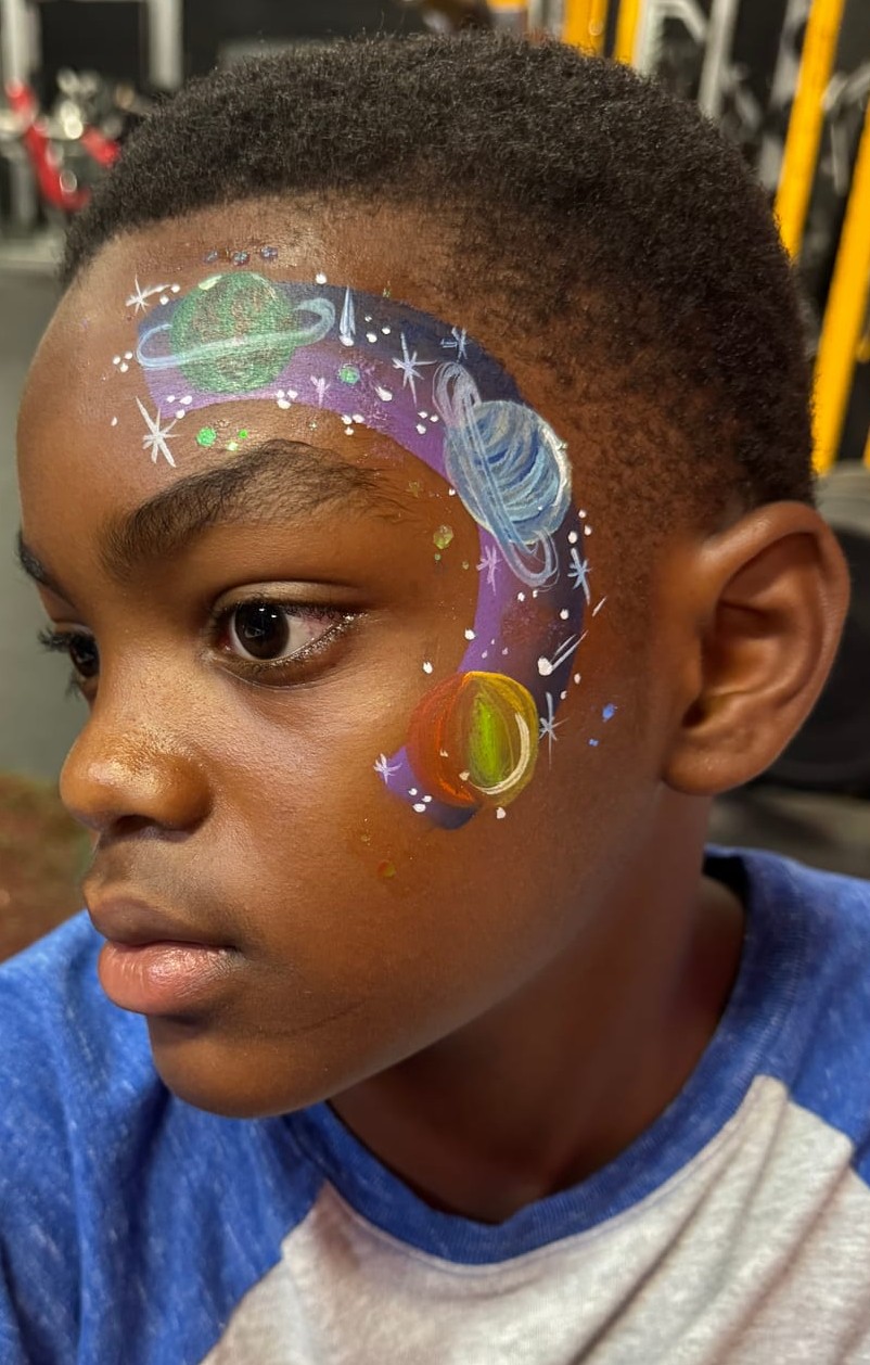 Galaxy and planets face painting on a boy at a Texas party