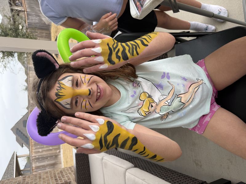 Tiger face and arm painting for a girl at a Texas event