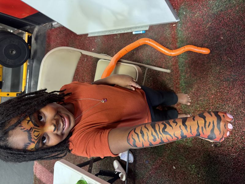 Tiger face and arm painting for a boy at a Texas birthday party